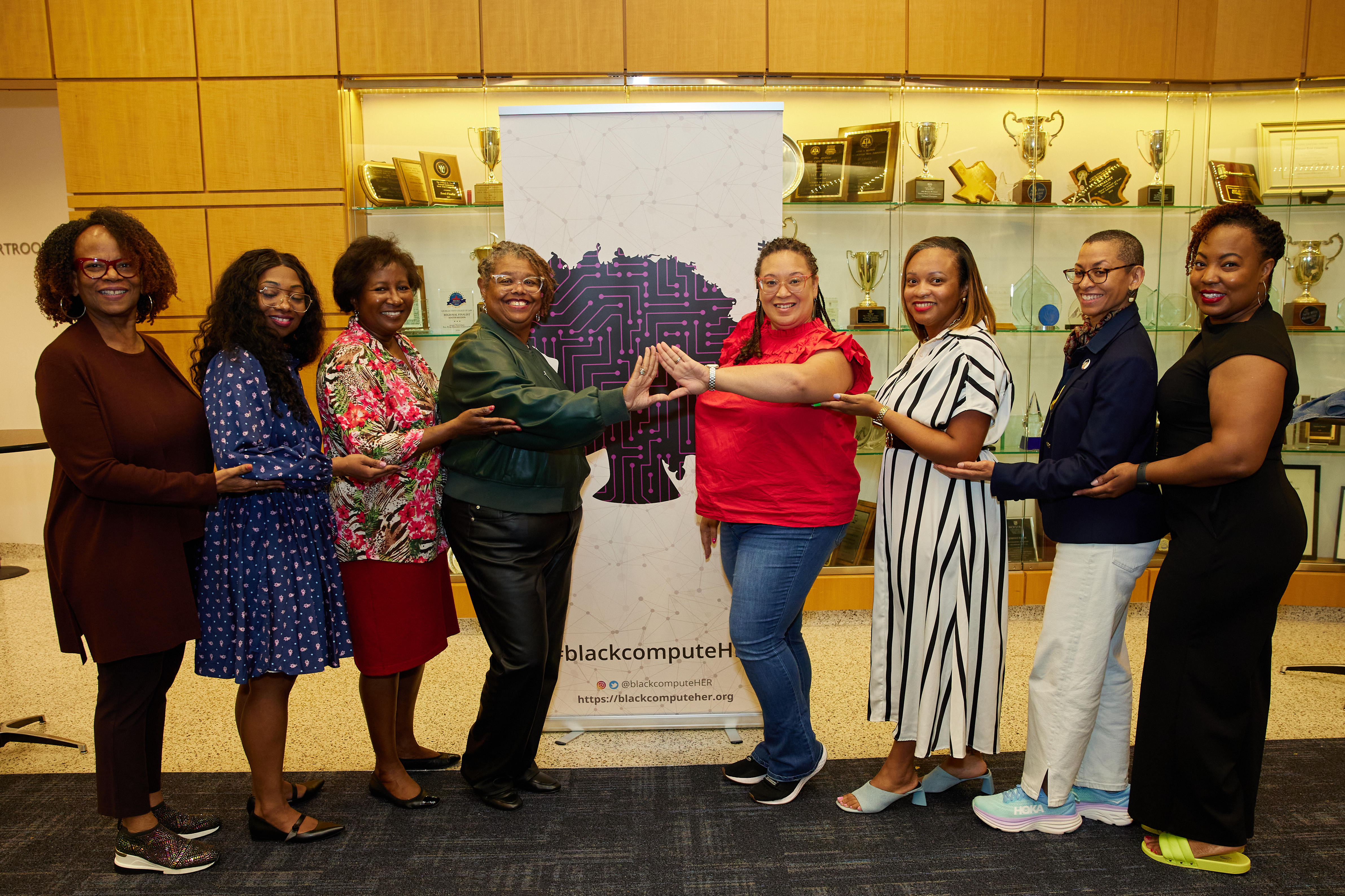 Members smiling together at a blackcomputeHER gathering
